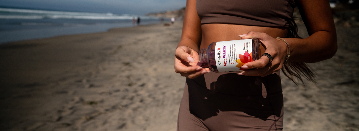 Woman holding Cellev8 Prime Recovery antioxidant gummies